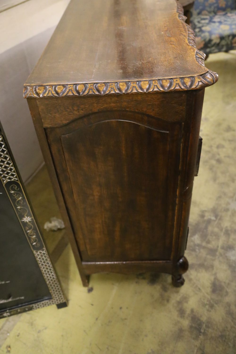 A 20th century French oak commode, fitted four long drawers with carved decoration, width 122cm, depth 43cm, height 92cm